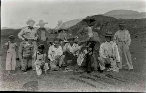 Imagen de Retrato con doble exposición de grupo de cazadores y un niño en una zona rural de Fresnillo, Zacatecas, no ubicada, con coche sedán al fondo (atribuido)